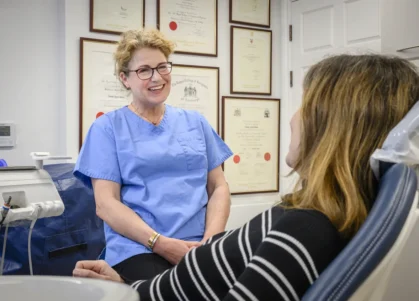 Dr Sarah Neale consulting with a patient in a treatment room